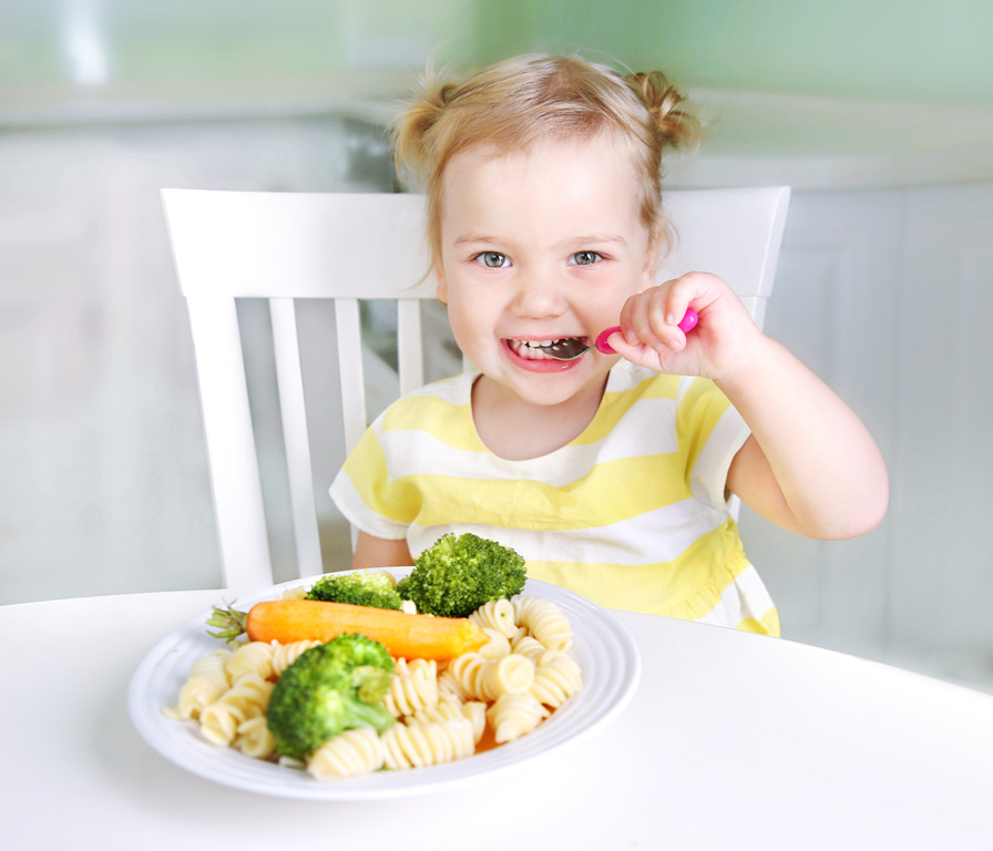 Child girl eating vegetables,healthy kid's nutrition.