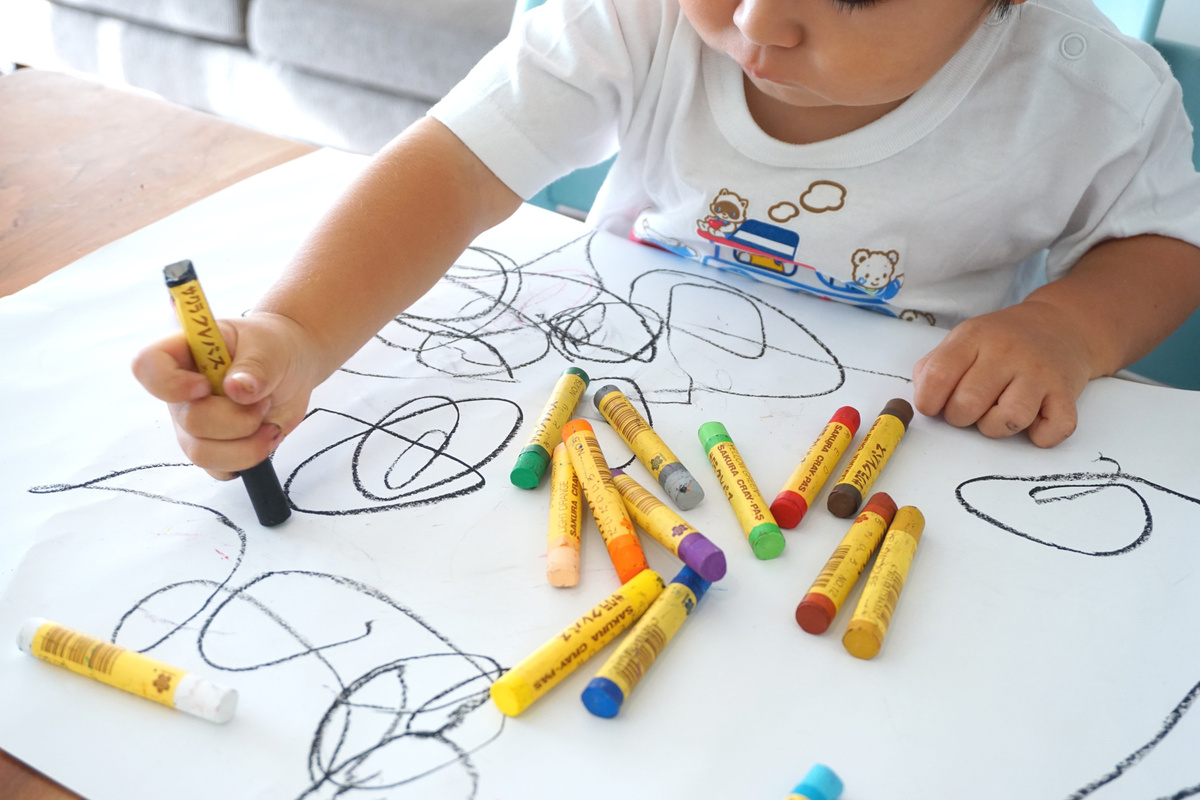 Kid Drawing with Crayons